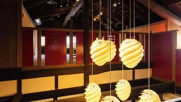 A modern interior with hanging spiral light fixtures and a wooden ceiling structure.