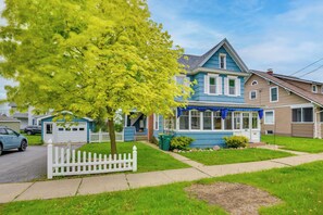 A two-story house with a blue exterior, a white picket fence, and a tree in the front yard. - Walk to Dtwn Clayton & River! 2-Unit Getaway (Clayton)