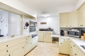 A compact kitchen with a dishwasher, oven, microwave, and a coffee maker. - Walk to Dtwn Clayton & River! 2-Unit Getaway (Clayton)