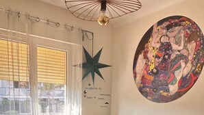 A bedroom with a bed, a star decoration, a wall art piece, and a desk with a printer. - The Good Life… (Fréjus)