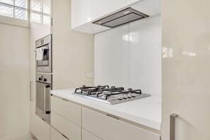 A modern kitchen with a gas stove, oven, and built-in microwave.