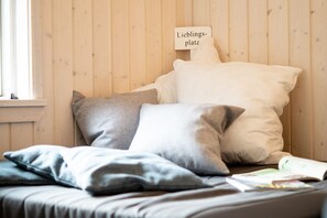 A bed with pillows and a sign above it. - Skandinavisches Haus für 10 (Großenbrode)