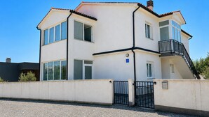 A two-story building with a flat roof, large windows, and a gated entrance. - 3 bedroom stunning apartment in Pula (Pula)