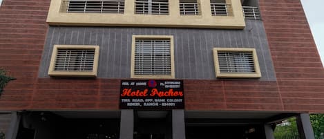 A multi-story building with a signboard for Hotel Anchor.