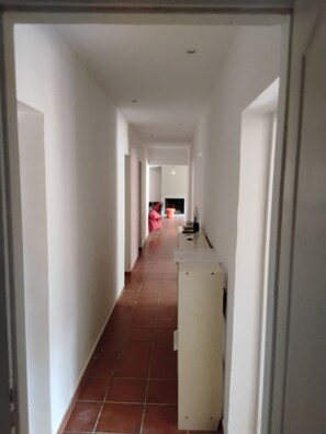 A corridor with a tiled floor, white walls, and a door at the end. - House in the Provençal countryside (Le Thoronet)