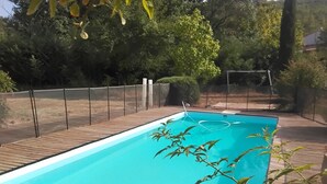 A rectangular swimming pool with a wooden deck surrounding it. - House in the Provençal countryside (Le Thoronet)