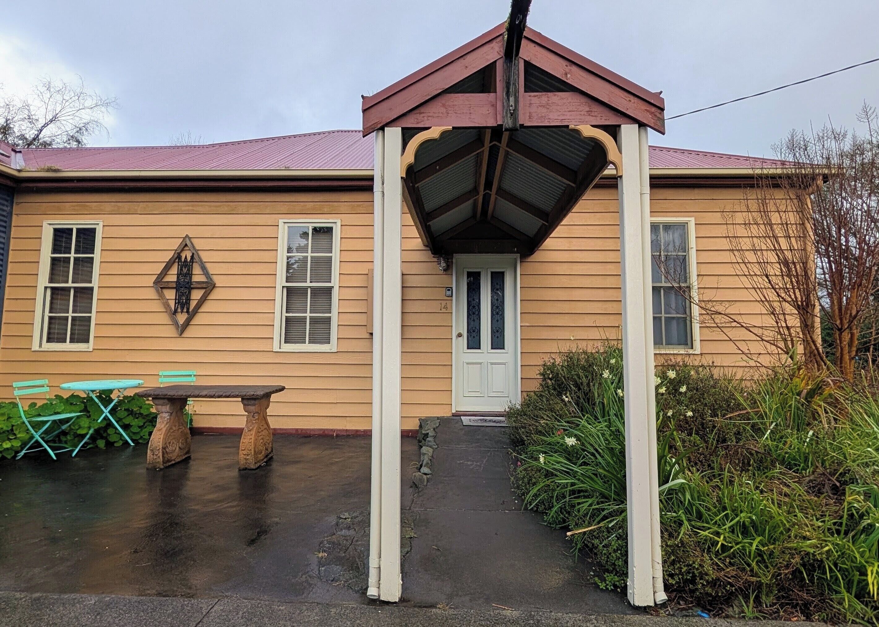 A house with a porch, a door, and a window.