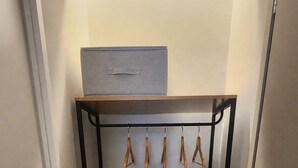 A closet with a wooden bench, a hanging rack, and a shelf. - ROOM 1 Studio apartment near downtown and the train station, with private parking (TORINO)