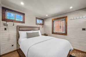 A comfortable queen bed in Cabin 1, surrounded by warm wood accents and natural light. - Fisherman`s Paradise | Double Lakefront Cabins (Panguitch)