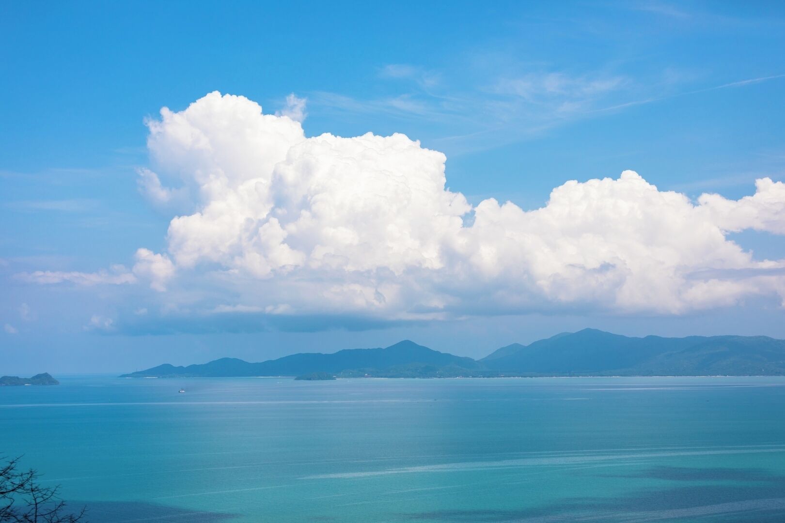A coastal landscape with clear skies and calm waters.