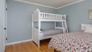 A bunk bed in a room with light blue walls and wooden flooring. - Oceanfront Home with Sweeping Pacific Views (Lincoln City)
