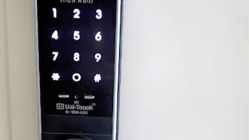 A Uni-Touch electronic keypad lock on a door.