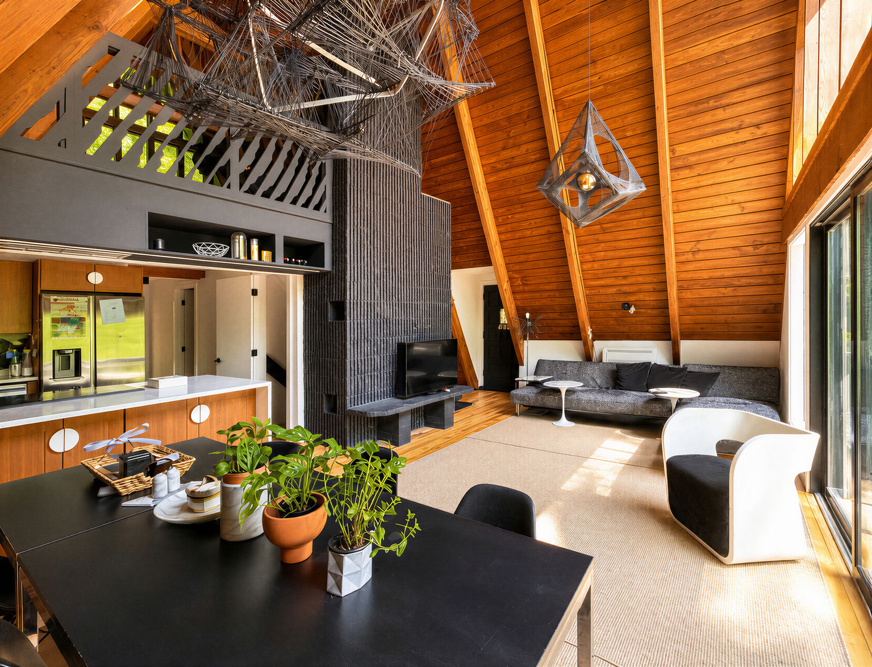 A modern interior with a kitchen, dining area, and seating space.