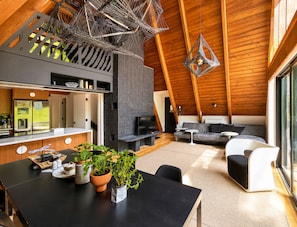 A modern interior with a kitchen, dining area, and seating space.