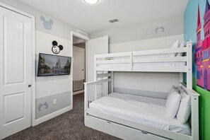 A child's bedroom with a bunk bed, a Mickey Mouse clock, and a Disney-themed wall mural. - PacMan, Foosball, Shuffleboard, Large Backyard, Chef Kitchen: Metropolis Estate (Kissimmee)