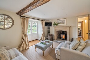 A cozy living room with a fireplace, a television, and a comfortable seating area. - Piddle Cottage  -  Chebbard, Dorchester (Chebbard)