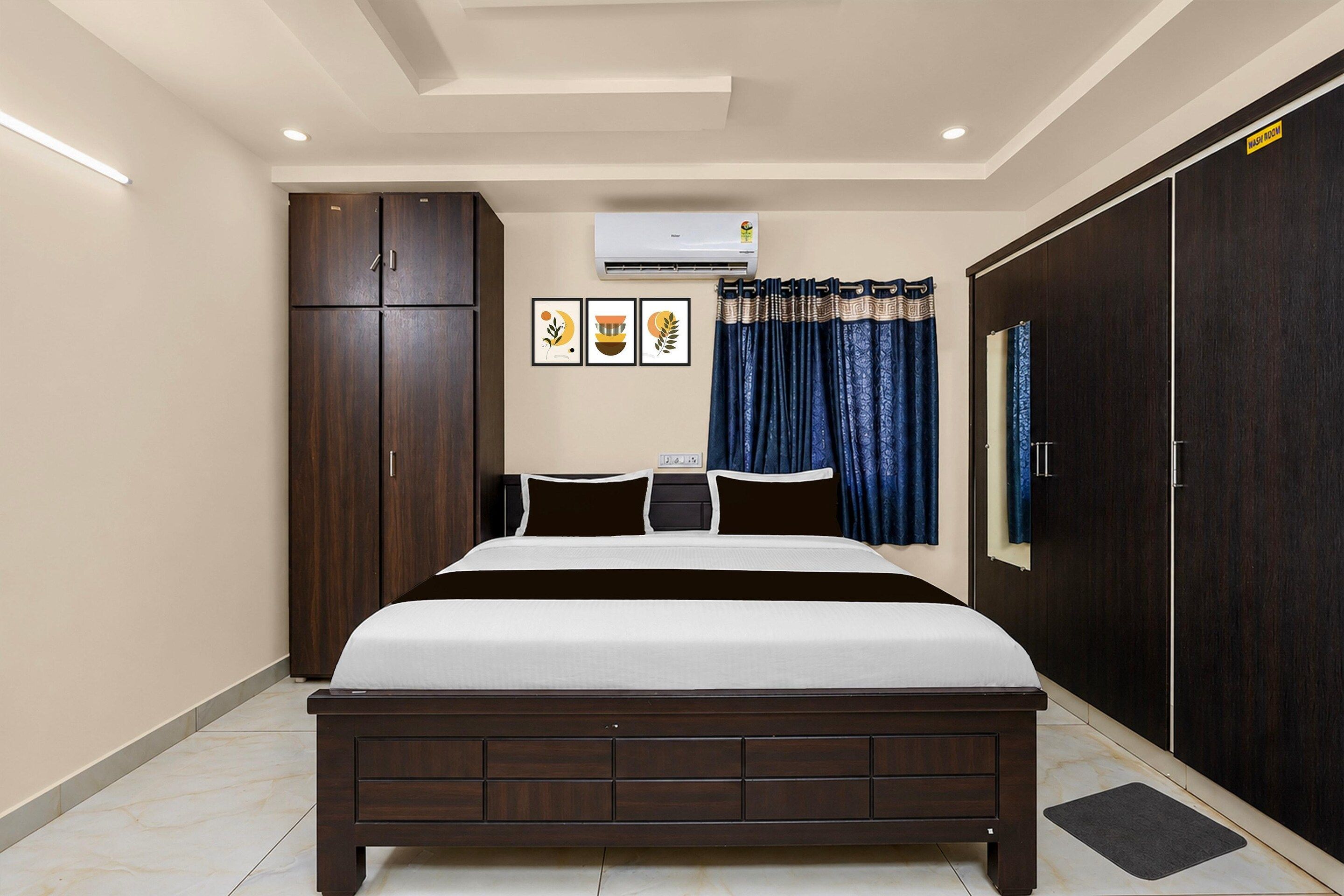 A bedroom with a bed, wardrobe, air conditioning unit, and a curtain.