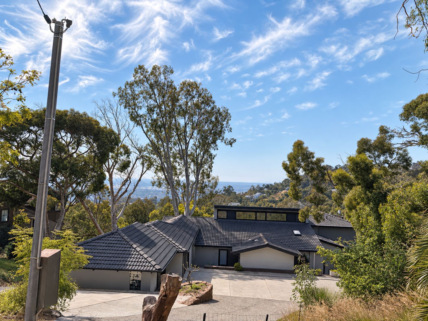 A residential building with a modern design, featuring a flat roof and a large garage.