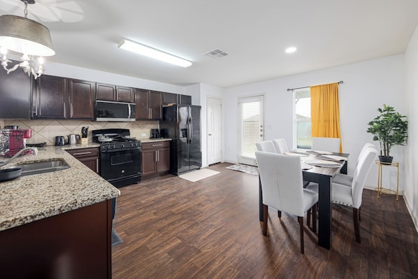 Open kitchen and dining spaces make it easy to cook, eat and spend time together without feeling crowded. An inviting setup for families, construction crews, corporate travelers and insurance housing guests enjoying longer stays in Kyle, TX.