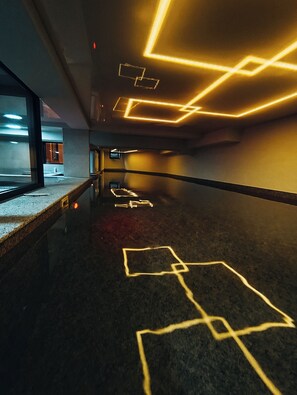 A corridor with geometric light patterns on the ceiling and floor. - Nature Heals by Todoroff (Devin)