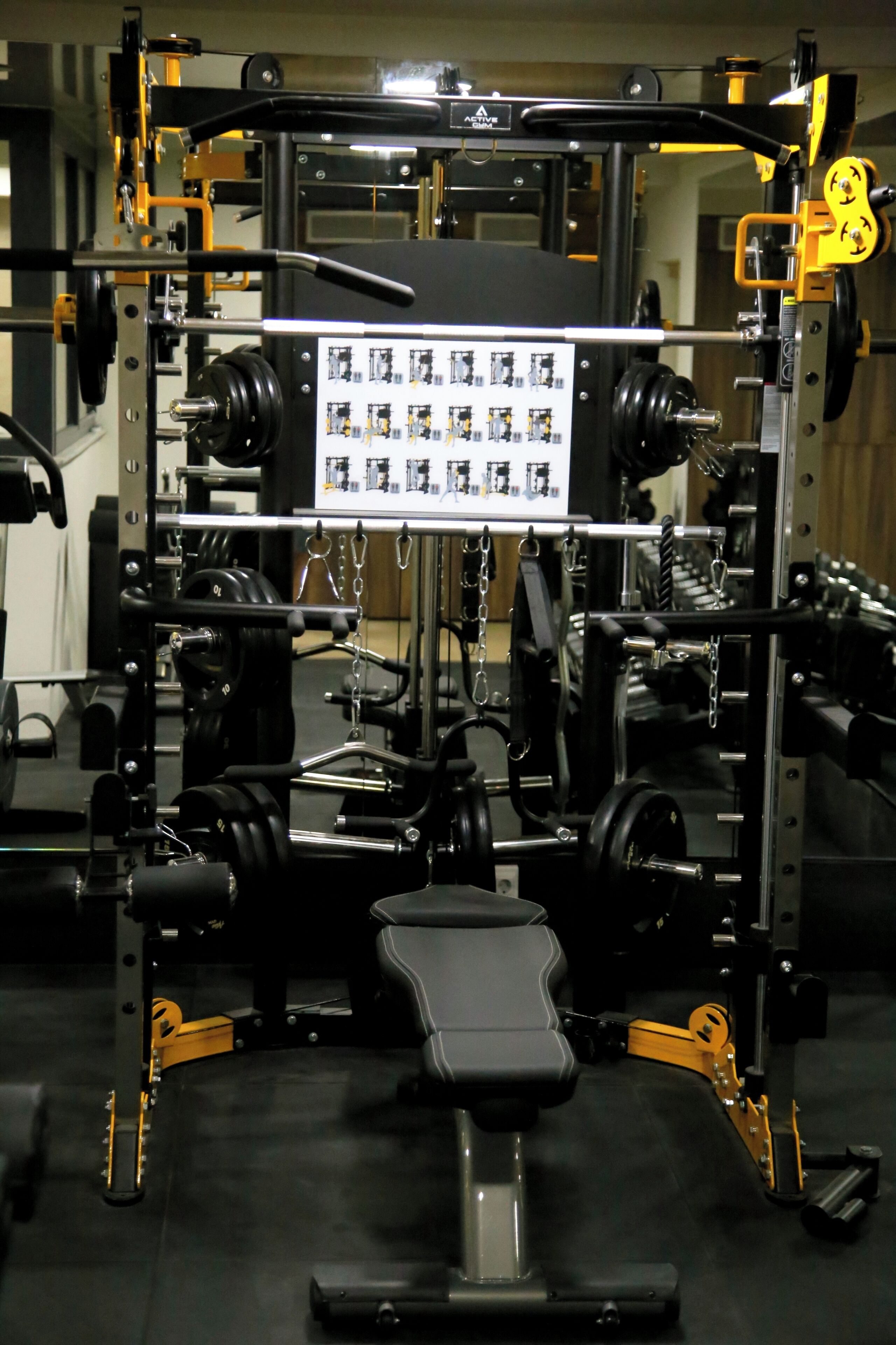A gym with a squat rack, benches, and weight plates.