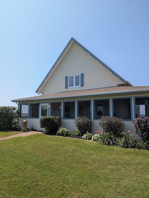 A single-story house with a gabled roof, a front porch, and a well-maintained lawn.