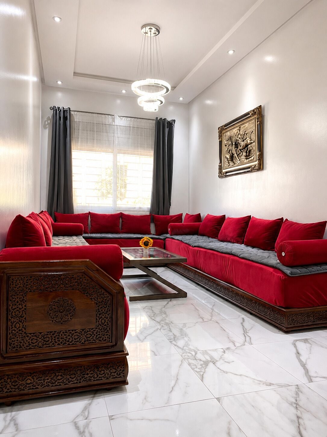 A modern living room with a sectional sofa, a coffee table, and a decorative wooden cabinet.