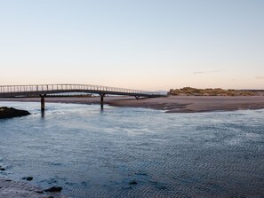 A bridge over a river with a sandy beach and rocky outcrops in the background. - Stunning private villa for 6 guests with TV and terrace (Lossiemouth)