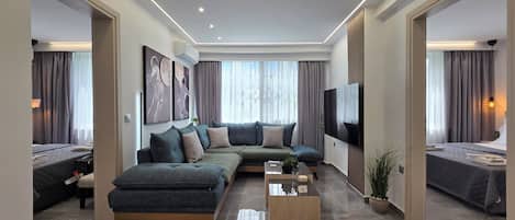 A modern living room with a sectional sofa, a flat-screen TV, and a coffee table.