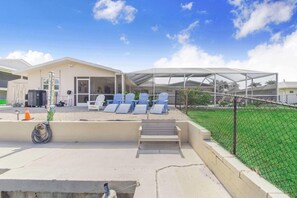 A building with a covered outdoor seating area, a fenced garden, and a clear sky. - Ga1970 3 Bedroom Home (Englewood)