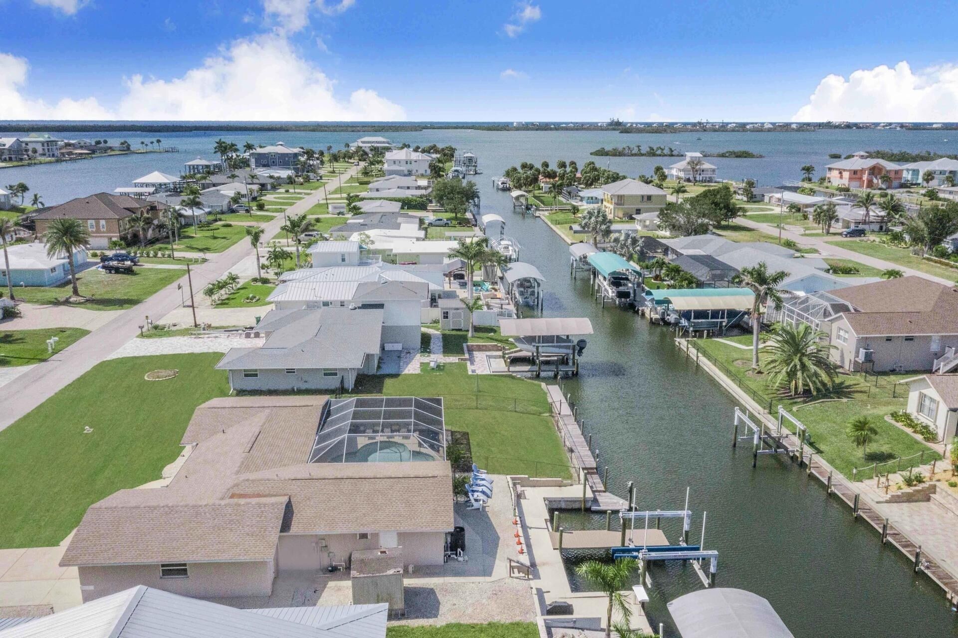 A residential area with houses, a canal, and a marina.