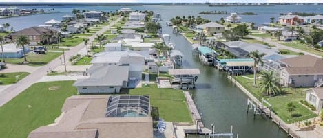 A residential area with houses, a canal, and a marina.