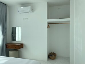 A bedroom with a bed, a bedside table, a mirror, an air conditioning unit, a wardrobe, and a hanging basket. - Green Mountain View villas Koh samui (Koh samui)