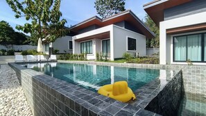 A modern pool area with a clear pool, a yellow float, and white lounge chairs. - Green Mountain View villas Koh samui (Koh samui)