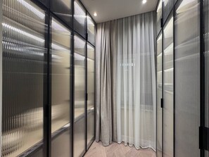 A room with a glass partition, a curtain, and a herringbone floor pattern. - Stylish stay in a heart of Yerevan between Republic Square and Opera (Yerevan)