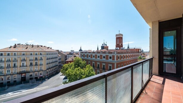 A balcony with a view of city buildings, including a prominent tower. - Sol Atelier | Apartments by Monaro* * * * * (Madrid)