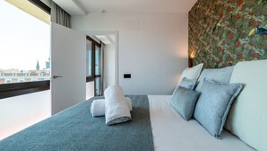A hotel room with a bed, a window, and a door leading to another room. - Sol Atelier | Apartments by Monaro* * * * * (Madrid)