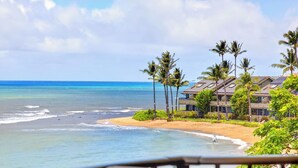 A beachfront property with a sandy beach, ocean view, and multiple buildings with balconies. - New Listing Oceanview Guaranteed (Lahaina)