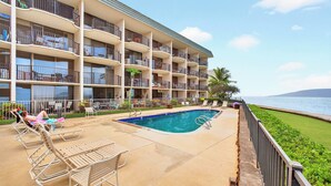 A hotel with a pool area, multiple balconies, and a view of the sea. - New Listing Oceanview Guaranteed (Lahaina)