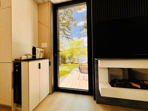 A modern kitchen with a built-in oven and a view of a deck and lake. - The Lake Villa
Cedar Sauna, Hot Tub, and Private Putting Green 
Escape for Two (Ingramport)