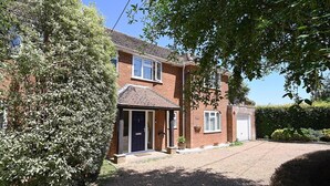 A two-story brick house with a front door, a garage, and a driveway. - Milcourt -  a managed house that sleeps 8 guests  in 4 bedrooms (Canterbury)