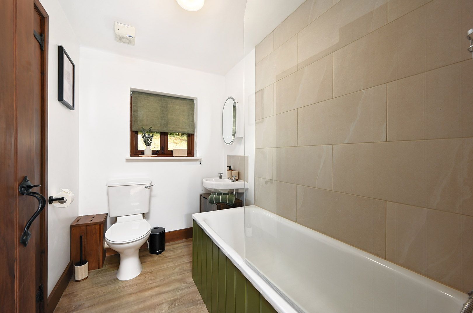 A bathroom with a toilet, sink, and bathtub.