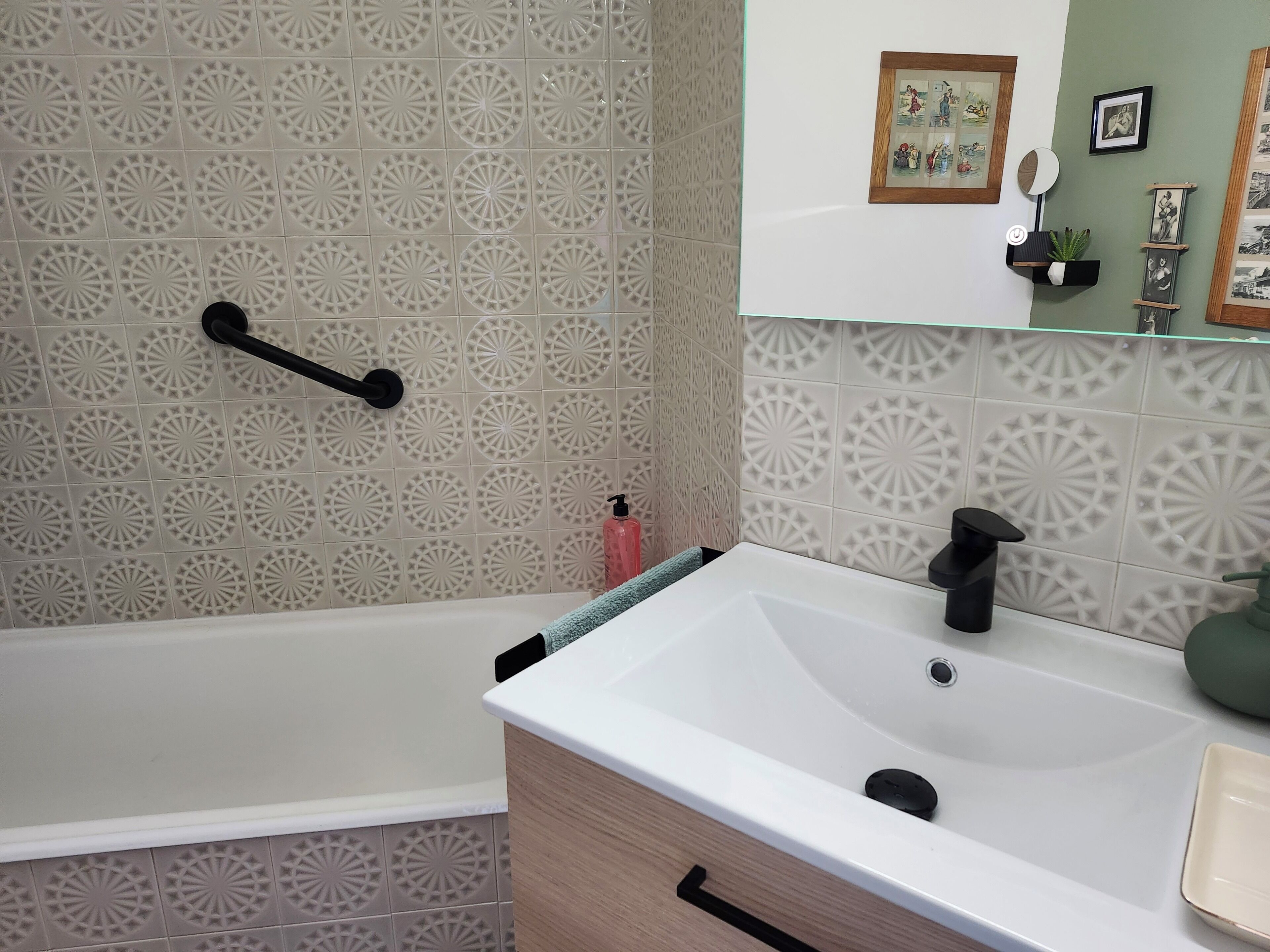 A bathroom with a bathtub, a sink, and a mirror.