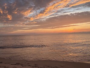 A beach with waves and a sunset sky. - Chic, coastal, pet-friendly retreat located in Lower Township, NJ. (Lower Township)