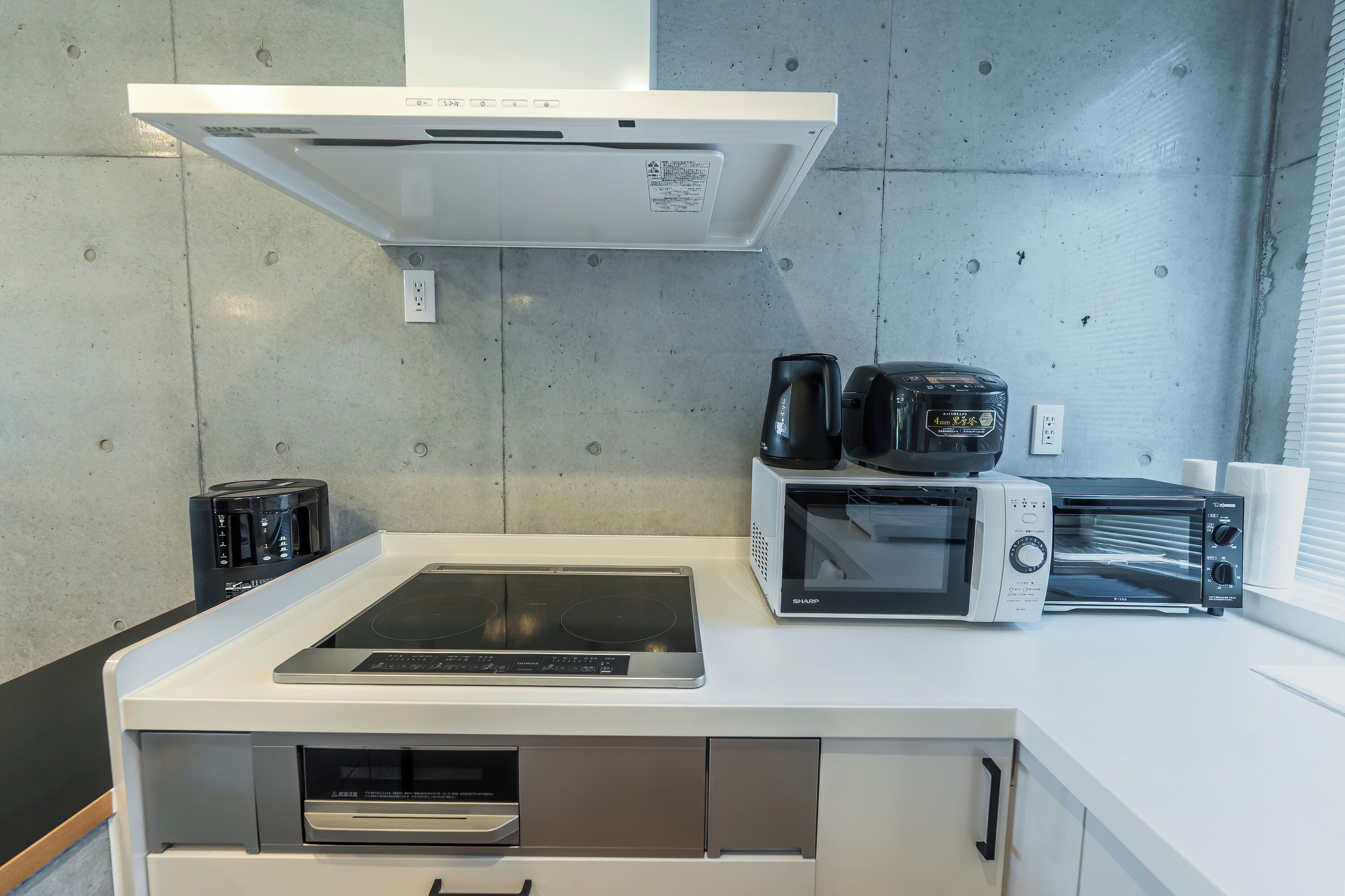 A kitchenette with a built-in oven, microwave, toaster, and coffee maker.