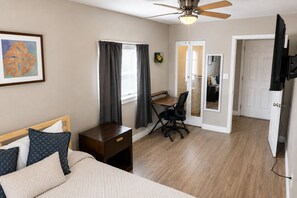 A bedroom with a bed, desk, chair, and a ceiling fan. - Near Downtown PHX 2BR Home - Sleeps 8 equipped with a 2 Car Garage (Phoenix)