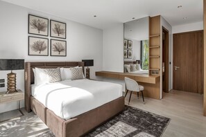 A modern bedroom with a large bed, a desk, a chair, and a wardrobe. - Botanica Foresta Luxury 4BR Villa • Private Pool (Thep Krasatti)