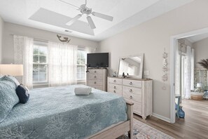 A bedroom with a bed, dresser, television, and a ceiling fan. - 2 bed 2 bath condo in Ocean Keyes, N. Myrtle Beach (North Myrtle Beach)