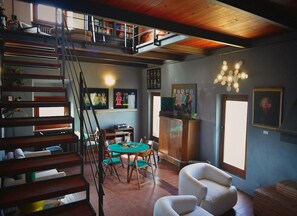 A multi-level living space with a staircase, dining area, and seating.