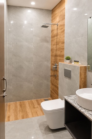 Un baño moderno con ducha, inodoro y tocador.